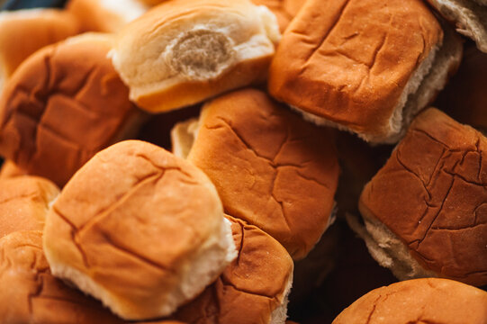 Closeup of a pile of brown hamburger buns at a picnic