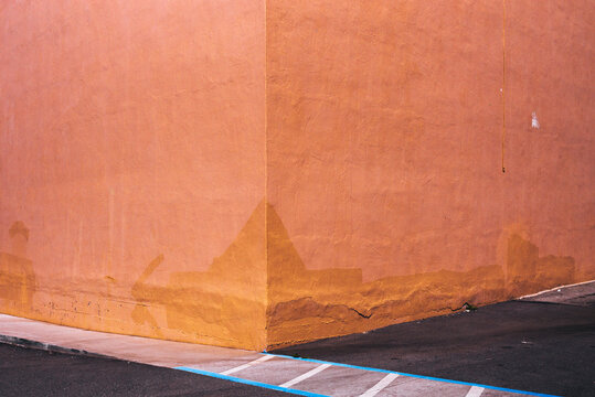 The pinkish-orange painted outside corner of a building in Pacifica, California