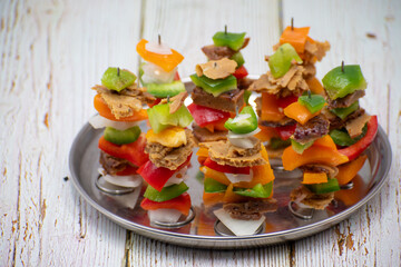 Air fried vegan barbeque  seitan and vegetables skewers served on banana leaf