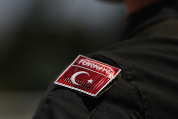 Details with the Turkish flag on the uniform of a Turkish soldier.