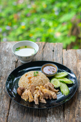 Steamed rice and chicken, served with soup and various sauce.