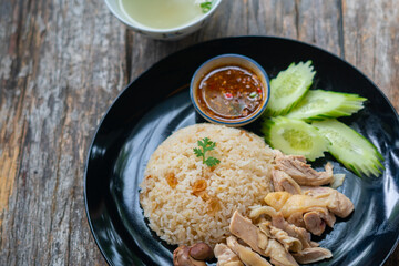 Steamed rice and chicken, served with soup and various sauce.