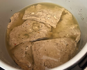 Vegan seitan schitzel slices in the process of making