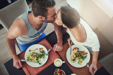 Love, romance and couple with breakfast, kiss and happy morning together in hotel room for...