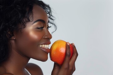 Woman, apple with face profile, nutrition, fruit, healthy diet on studio background. Happier female eating, wellness, and lifestyle with organic and fresh produce weight loss