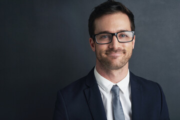 Businessman, portrait and glasses in studio with smile, financial career in corporate company. Male accountant, mockup and black background with happiness for job, formal suit in New York City