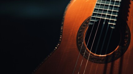 Obraz premium Acoustic guitar on a black background (with copy space)