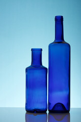 Blue empty glass water bottles on a table