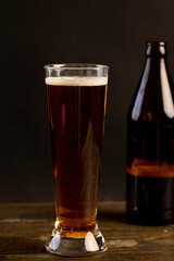 dark beer in a glass glass, fresh dark alcoholic beer