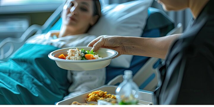 Nurse Serving Food to Recovering Patient.