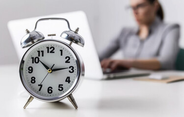 woman working with clock on office desk