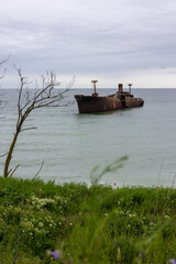 An old wreck abandoned at sea. The wreck of a ship near shore.