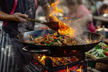 a person cooking food on a grill with flames