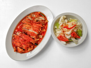 Chicken baked with onion in tomatoes with white cabbage salad.