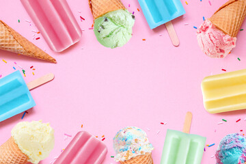 Various colorful pastel summer ice cream cones and popsicle frozen desserts. Above view frame on a...