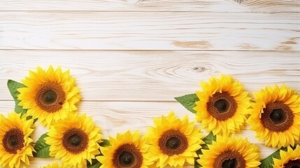 Bright sunflowers border on light wooden background with copy space