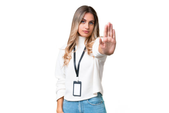Young Uruguayan woman with ID card over isolated background making stop gesture