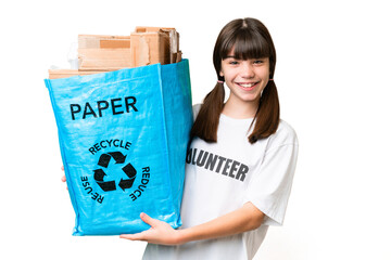 Little Caucasian girl holding a recycling bag full of paper to recycle over isolated background smiling a lot