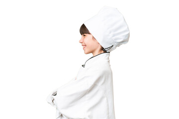 Little caucasian chef girl over isolated background in lateral position