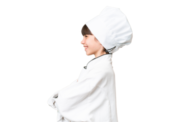 Little caucasian chef girl over isolated background in lateral position