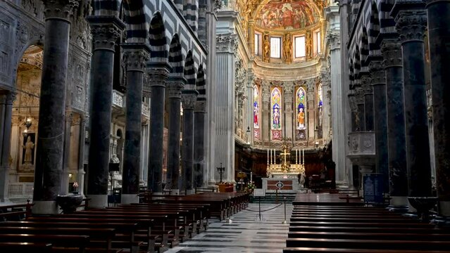 Genoa, Liguria, Italy May 18, 2024. Tilt footage on the main nave of the cathedral of San Lorenzo. The brightness and the use of gold in the apse are striking.