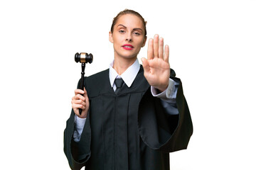 Judge caucasian woman over isolated background making stop gesture