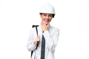 Young architect woman with helmet and holding blueprints over isolated background happy and smiling