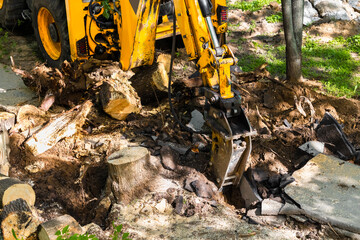 excavator with hydraulic hammer breaks old asphalt © Oleg Opryshko