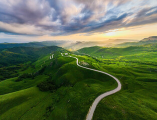 Panoramic view of the green mountains and hills at sunset. Gumbashi Pass in North Caucasus, Russia.