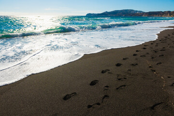 Santorini island, Greece. Vlichada beach with black volcanic sand.