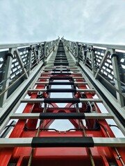 A very long extended ladder for rescuing people on a fire engine.