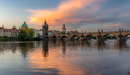 Fototapeta premium Colorful sunrise over Charles Bridge (Karluv Most) over Vltava River in Prague, Czech Republic