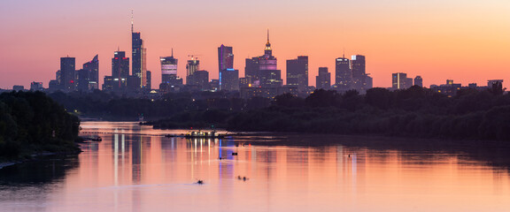 Panorama of Warsaw downtown skyline, Poland, over Vistula river during sunset