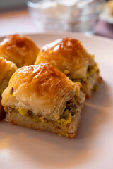 Local Turkish baklava on a white plate in a 360 degree rotating display case