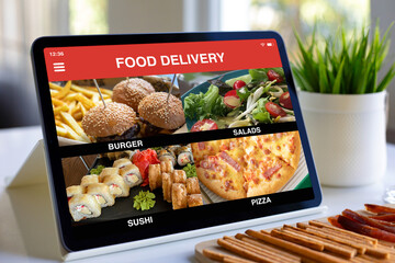 computer tablet with food delivery application on screen in cafe