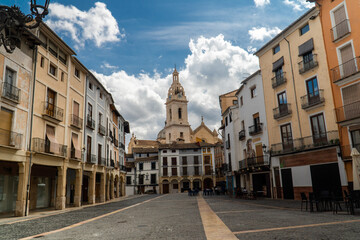 Bell tower in Xativa town, against blue cloudy sky. 