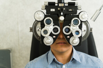 Closeup of a patient having an eye examination with a phoropter during a visit to an...