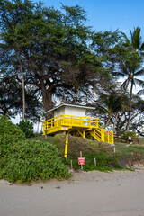 Bright yellow lifeguard shack, closed for the night, at sunset, tropical vacation paradise in the Hawaiian Islands, Maui, Hawaii
