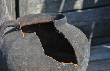 broken old clay jug close-up. blurred background