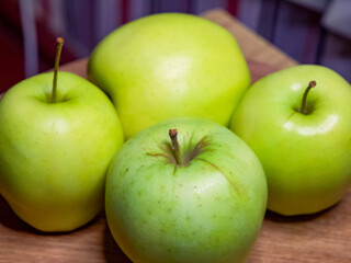 Bright green apples, arranged neatly, imply a focus on organic produce in a market setting.