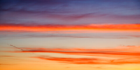 A serene sunset painting the sky with hues of orange, blue, and purple, evoking a sense of calm....