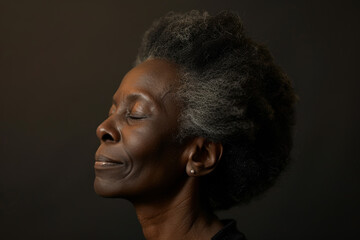 Obraz premium A close up of a black woman's face with her eyes closed looking to a side
