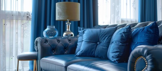 Cozy living room with a blue leather couch, blue decorative pillows, and blue drapes