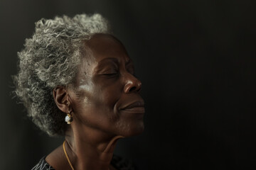 A close up of a black woman's face with her eyes closed looking to a side