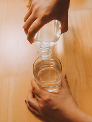 healthy beautiful young woman holding glass of water