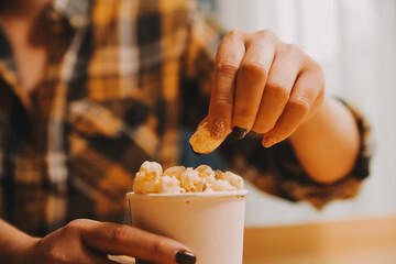 A woman holding a bowl of popcorn