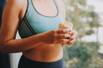 A woman holding a bowl of popcorn