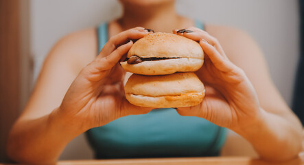 Binge eating disorder concept with woman eating fast food burger, fired chicken , donuts and...