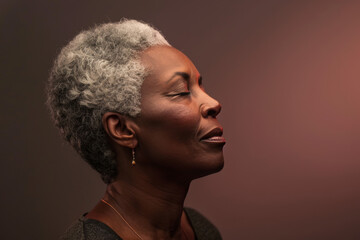 A close up of a black woman's face with her eyes closed looking to a side