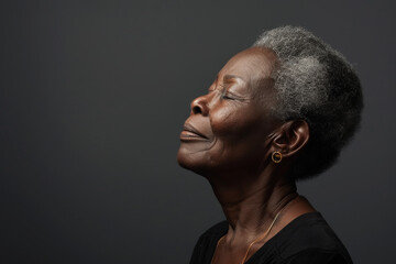 Obraz premium A close up of a black woman's face with her eyes closed looking to a side